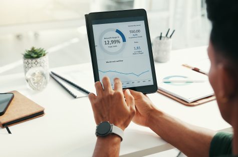 Hands, financial report and tablet screen with business person in office for accounting or budget. Hands, financial report and tablet screen with business person in office for accounting or budget.